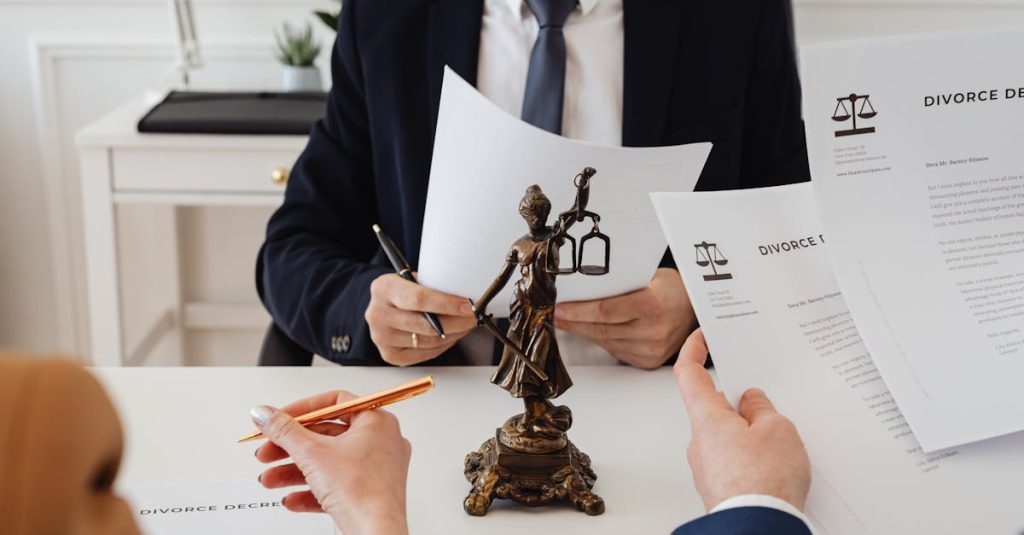 Legal professionals reviewing divorce documents in a law office with a Lady Justice statue.